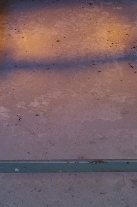 light from the fire in the kiln reflecting onto the floor