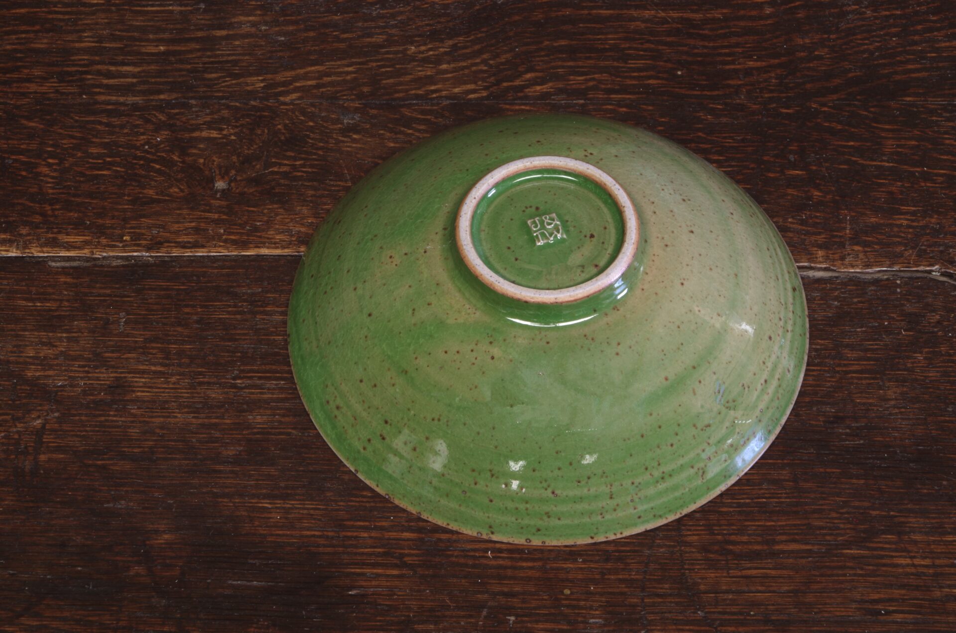 Thrown stoneware open bowl with green glaze by award winning potters James and Tilla Waters in Carmarthenshire, Wales, UK