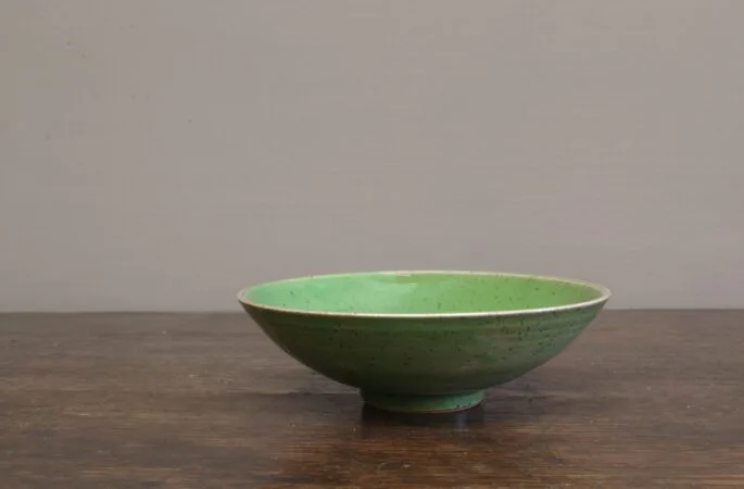 Thrown stoneware open bowl with green glaze by award winning potters James and Tilla Waters in Carmarthenshire, Wales, UK