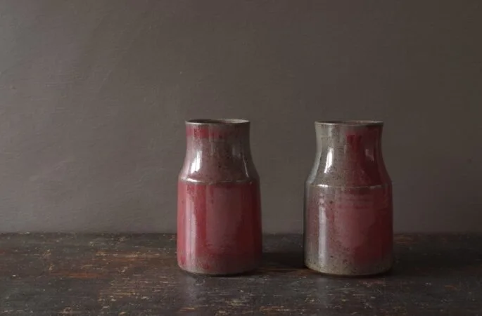 wheel thrown dark stoneware vase with copper red glaze reduction fired by award winning potters James and Tilla Waters in Carmarthenshire, Wales, UK