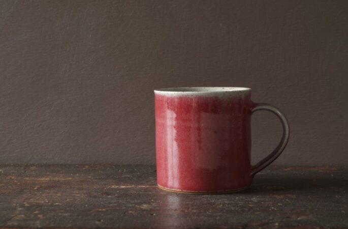 wheel thrown reduction fired stoneware "square" mug with copper red glaze by award-winning potters James and Tilla Waters in Carmartheshire, Wales, UK