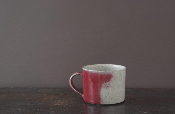 Wheel thrown stoneware breakfast mug with copper red glaze by award winning potters James and Tilla Waters in Carmarthenshire, Wales, UK