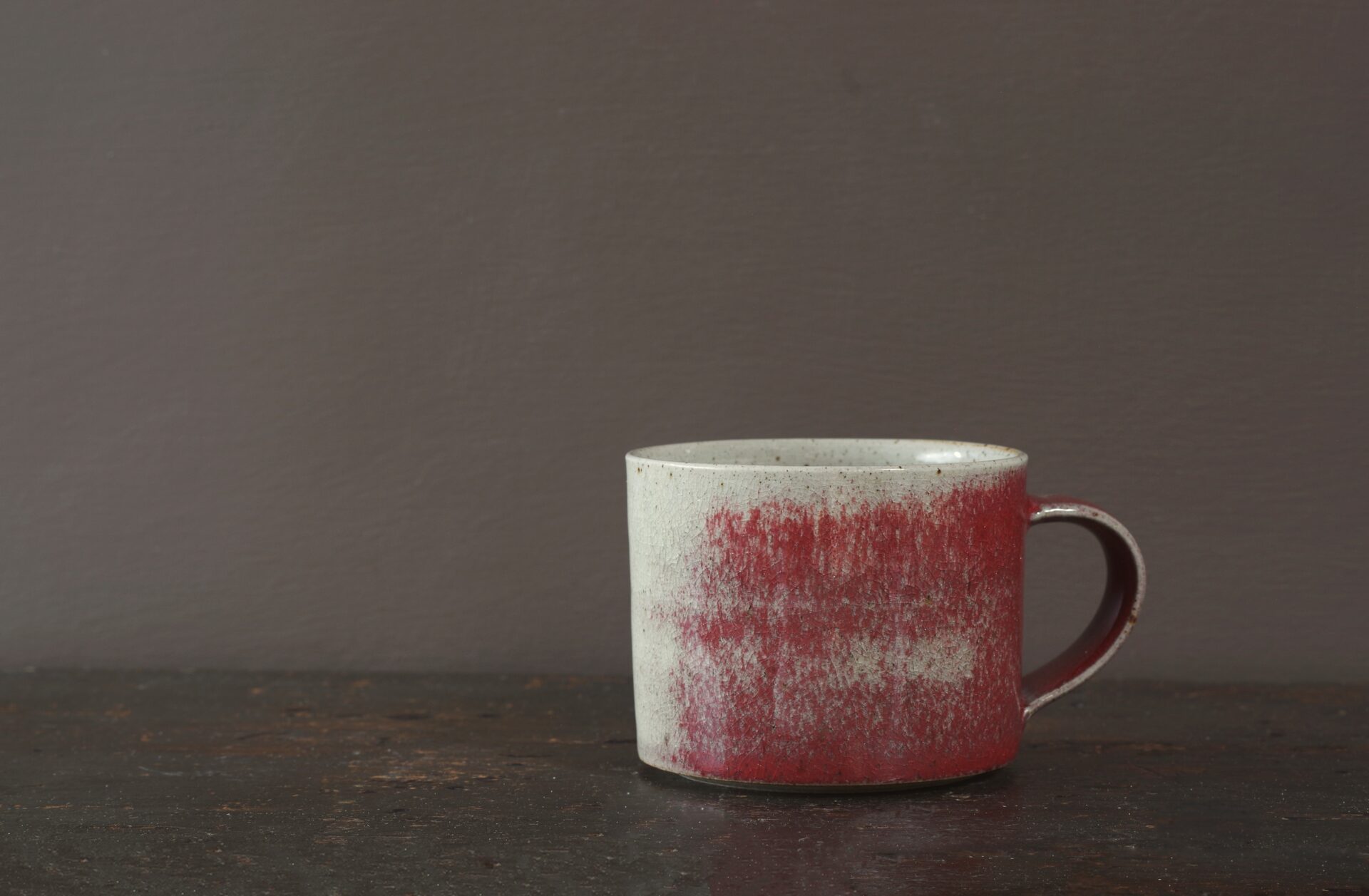 Wheel thrown stoneware breakfast mug with copper red glaze by award winning potters James and Tilla Waters in Carmarthenshire, Wales, UK