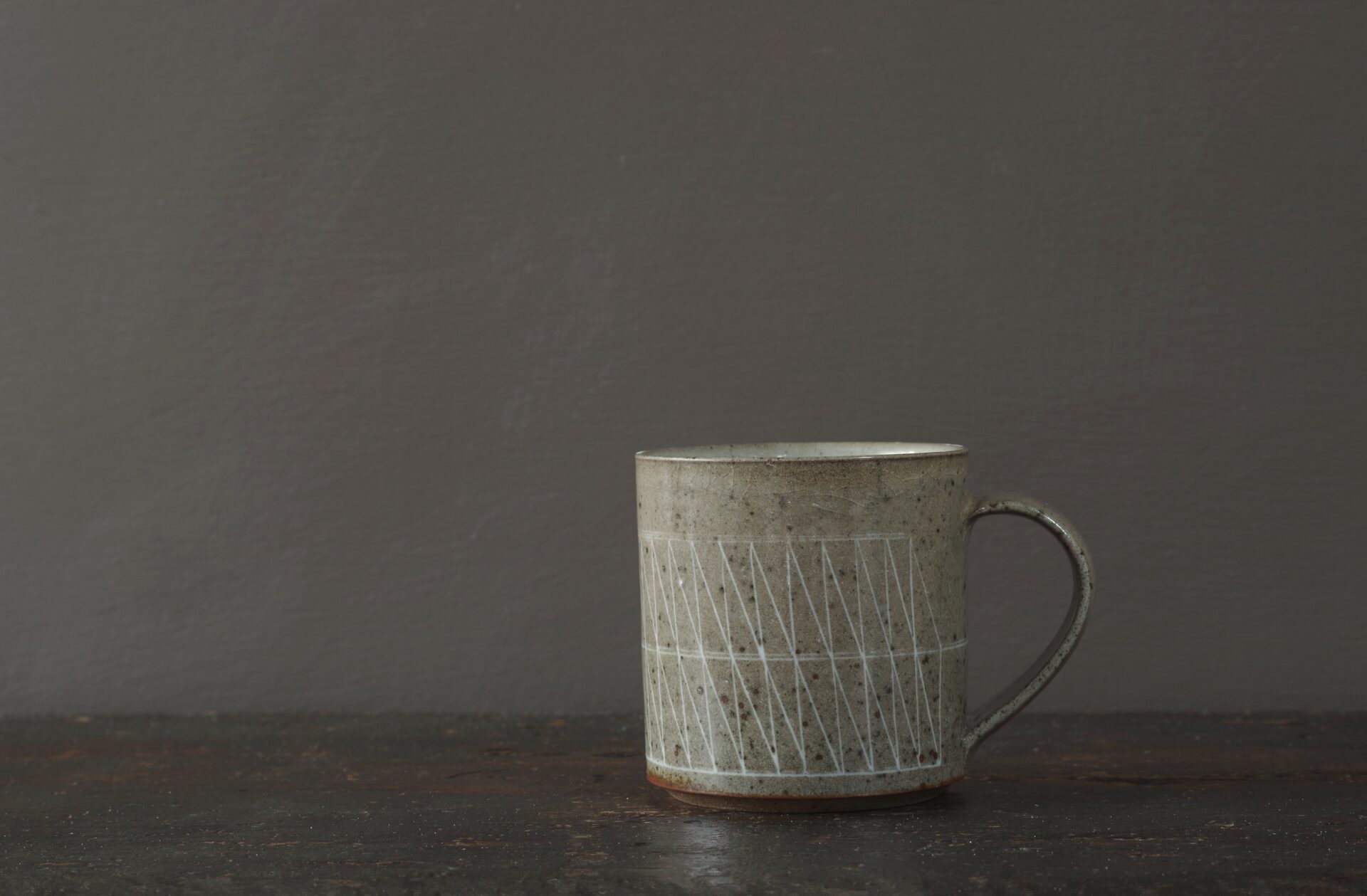 reduction fired stoneware mug (8cm x 8cm) with inlaid geometric decoration and pulled handle by award winning potters James and Tilla Waters in Carmartheshire, Wales, UK