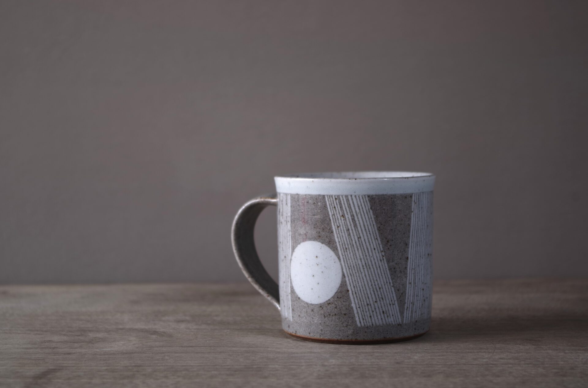 reduction fired stoneware mug (8cm x 8cm) with sgraffito abstract decoration and pulled handle by award winning potters James and Tilla Waters in Carmartheshire, Wales, UK