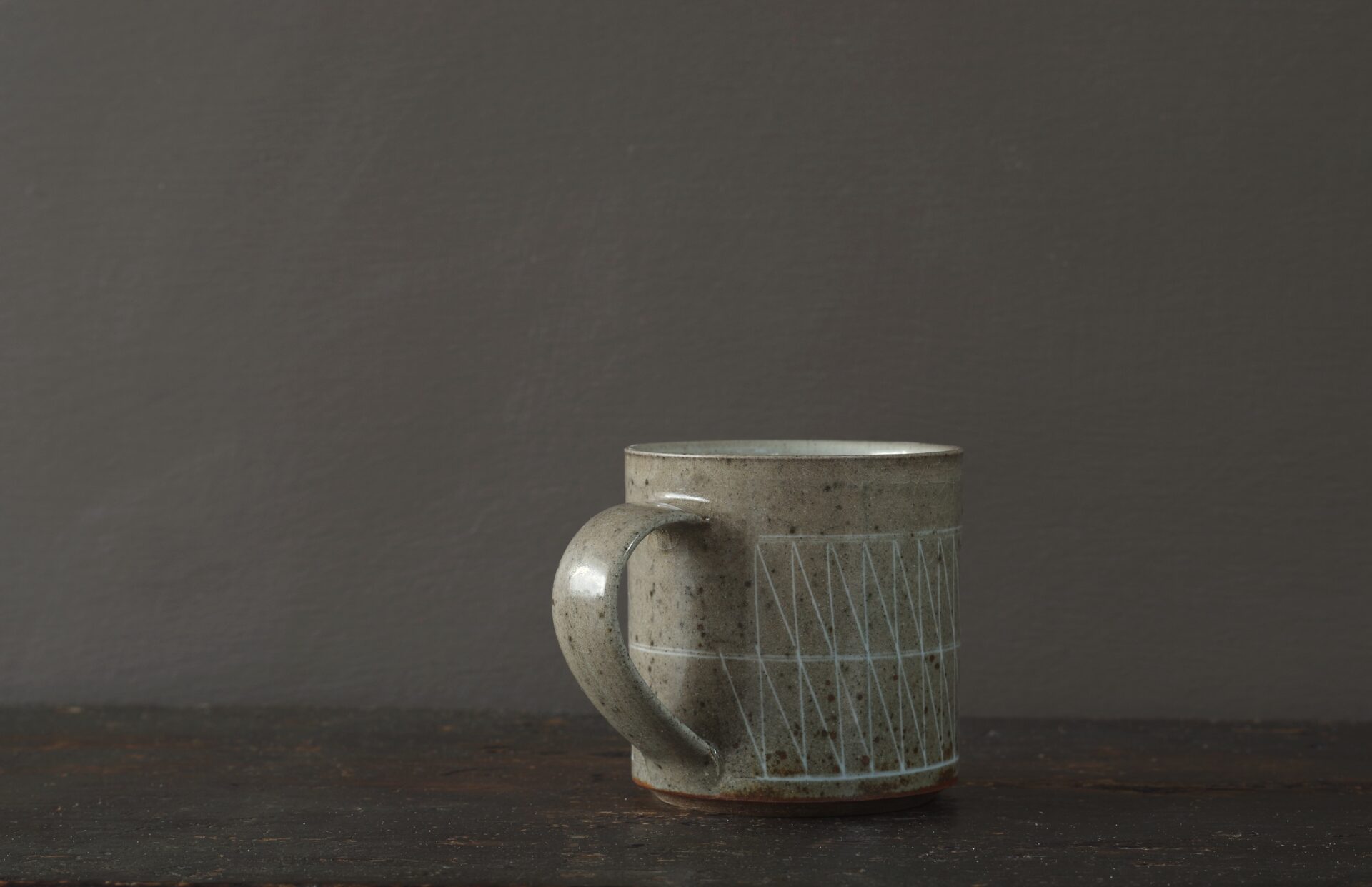 reduction fired stoneware mug (8cm x 8cm) with inlaid geometric decoration and pulled handle by award winning potters James and Tilla Waters in Carmartheshire, Wales, UK
