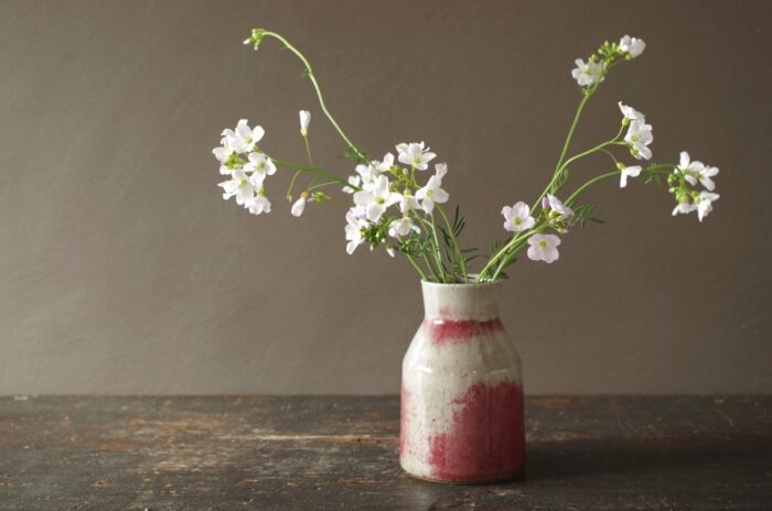 Reduction fired stoneware vase with patchy copper red glaze by award winning studio potters James and Tilla Waters in Carmarthenshire, Wales, UK