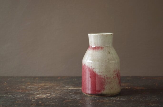 Reduction fired stoneware vase with patchy copper red glaze by award winning studio potters James and Tilla Waters in Carmarthenshire, Wales, UK
