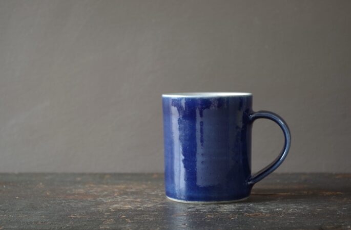 Reduction fired, wheel thrown, stoneware small mug with pulled handle and cobalt blue glaze by award winning studio potters James and Tilla Waters in Carmarthenshire, Wales, UK