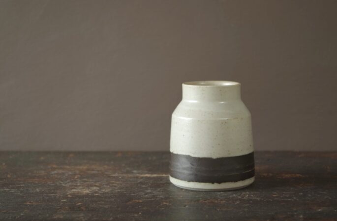 Reduction fired raw glazed stoneware vase with black band by award winning studio potters James and Tilla Waters in Carmarthenshire, Wales, UK
