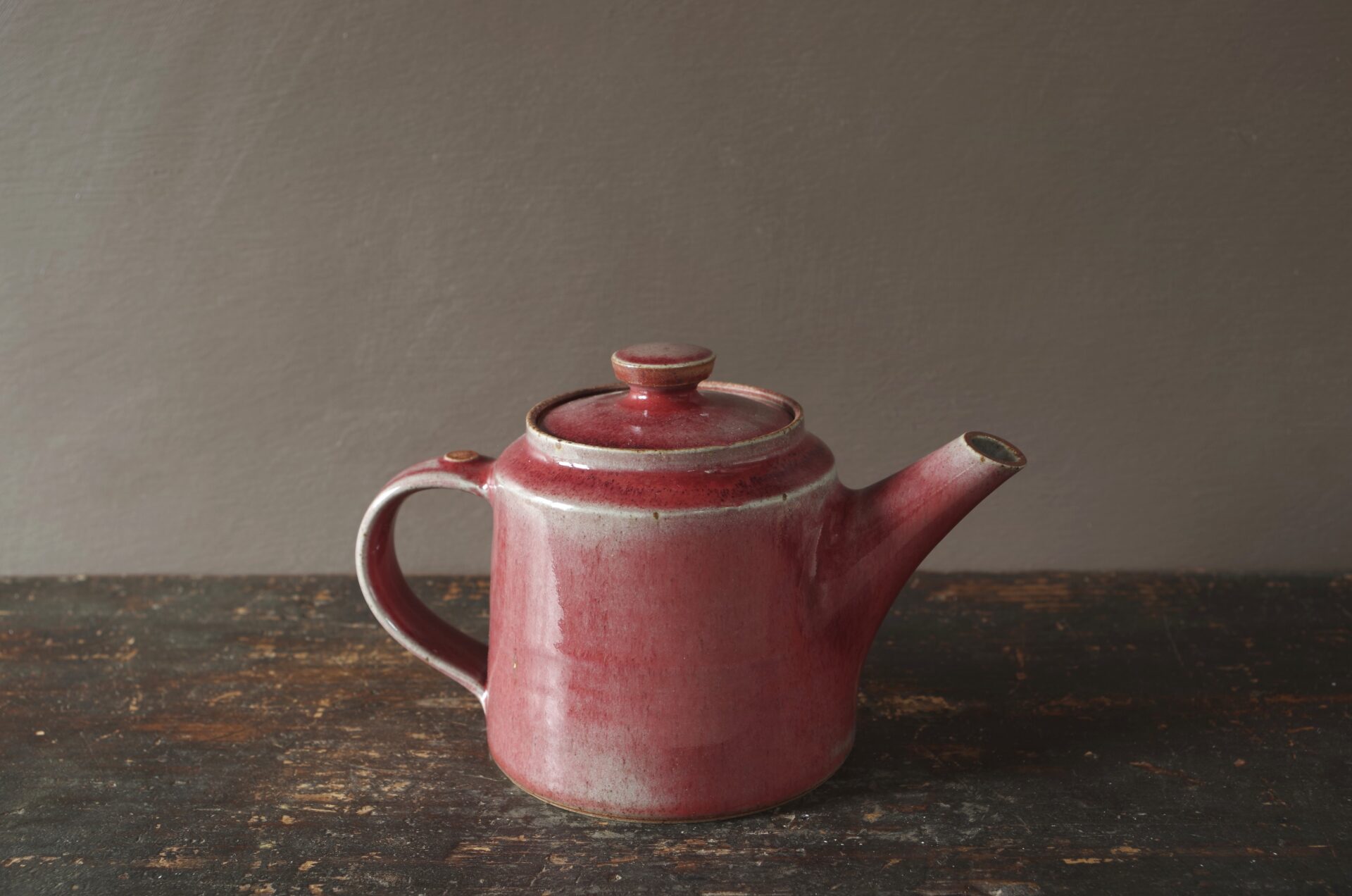 wheel thrown, reduction fired stoneware teapot with pulled handle and copper red glaze by award winning potters James and Tilla Waters in Carmarthenshire, Wales, UK