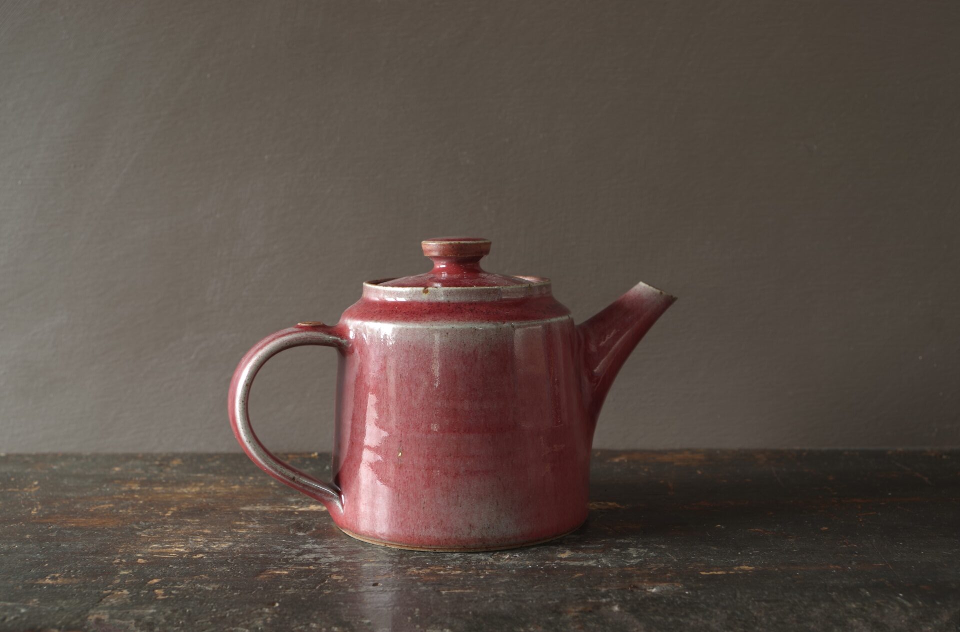 wheel thrown, reduction fired stoneware teapot with pulled handle and copper red glaze by award winning potters James and Tilla Waters in Carmarthenshire, Wales, UK