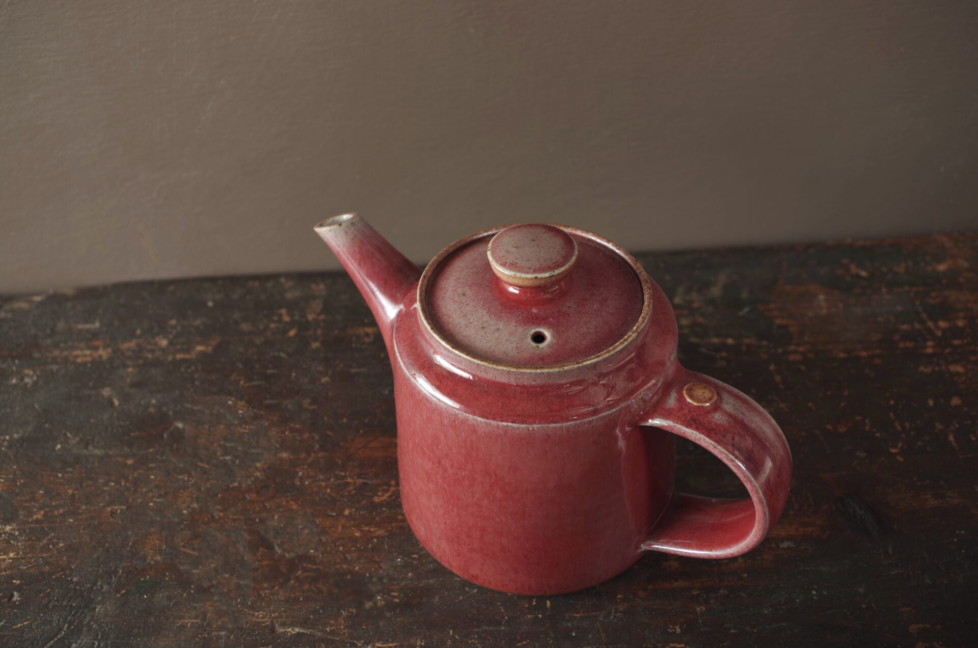 wheel thrown, reduction fired stoneware teapot with pulled handle and copper red glaze by award winning potters James and Tilla Waters in Carmarthenshire, Wales, UK