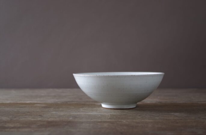 18cm diameter wheel thrown stoneware bowl with off white glaze by award winning potters James and Tilla Waters in their studio in Carmathenshire, Wales UK