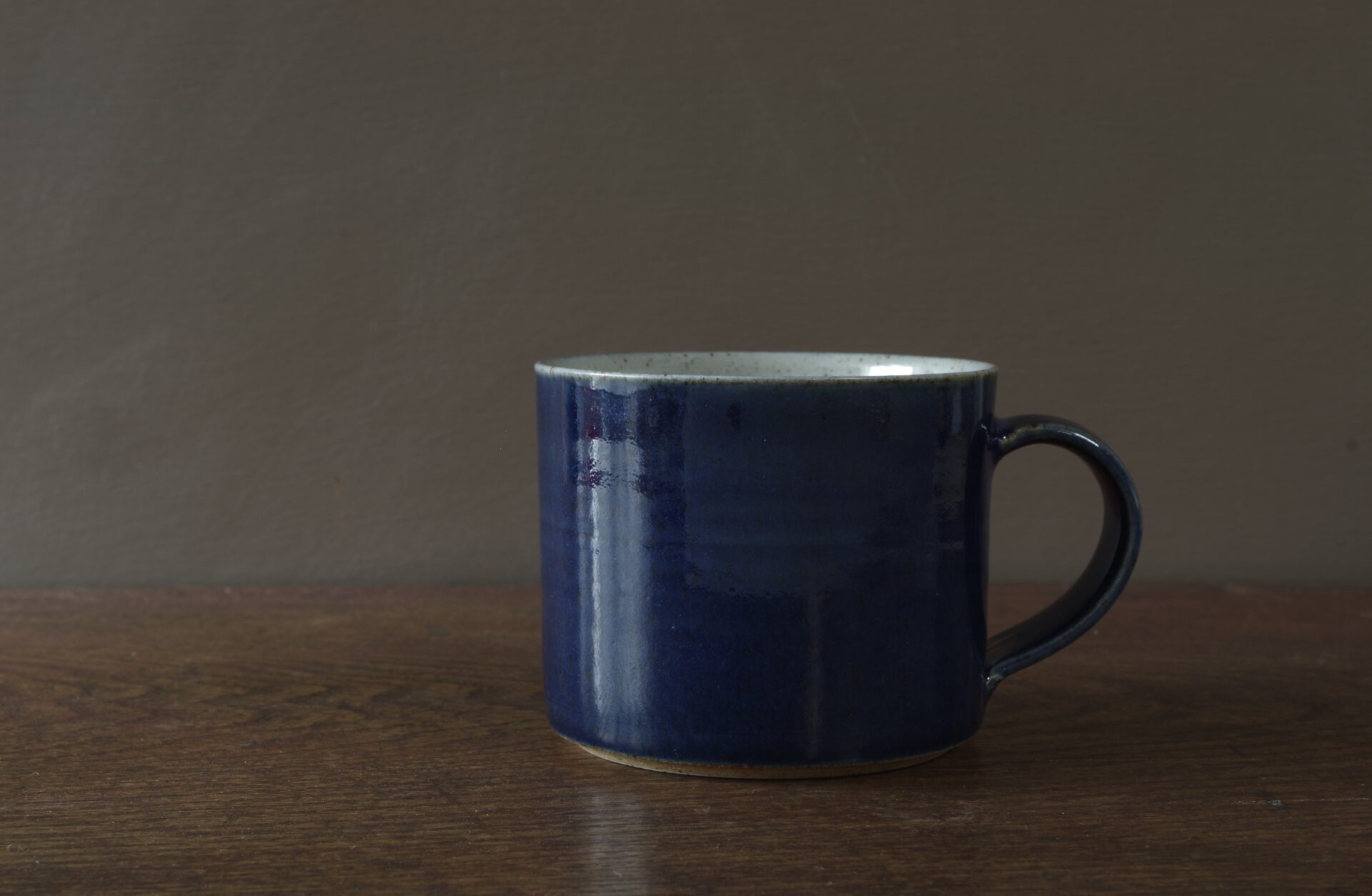 reduction fired stoneware large breakfast mug with dark blue glaze by award winning potters James and Tilla Waters in Carmarthenshire, Wales, UK