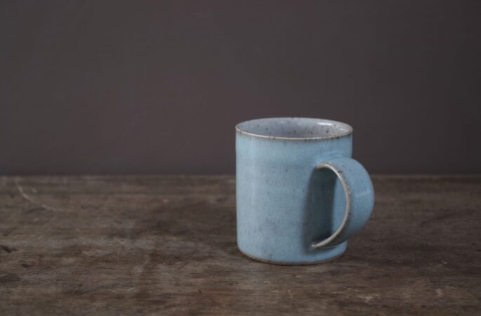 Wheel thrown stoneware mug with pale blue chun glaze by award winning potters James and Tilla Waters in Carmarthenshire, Wales, UK