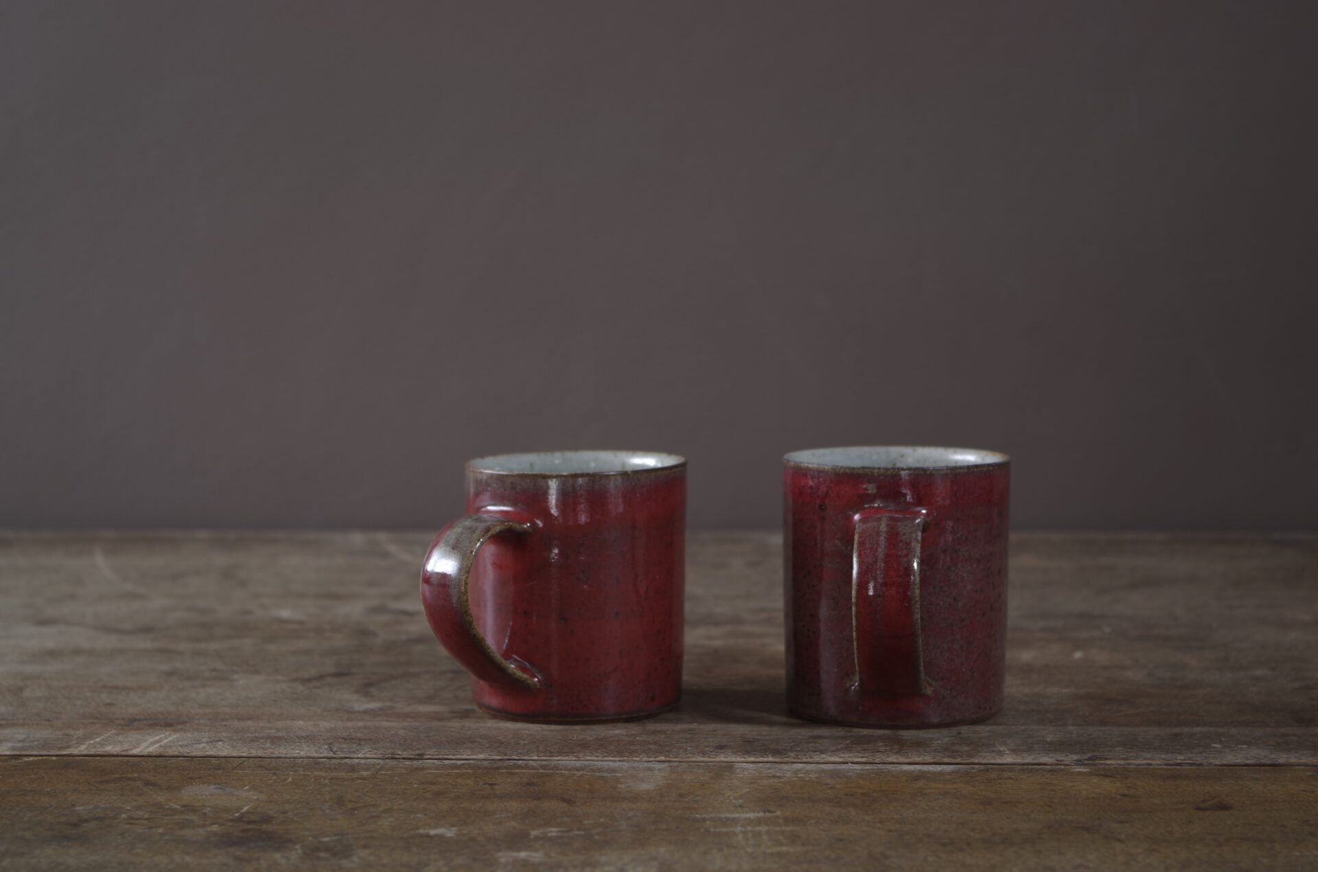 Wheel thrown stoneware mug with copper red glaze by award winning potters James and Tilla Waters in Carmarthenshire, Wales, UK