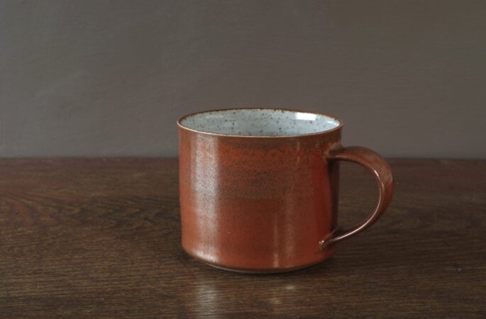 reduction fired stoneware large breakfast mug with persimmon glaze by award winning potters James and Tilla Waters in Carmarthenshire, Wales, UK