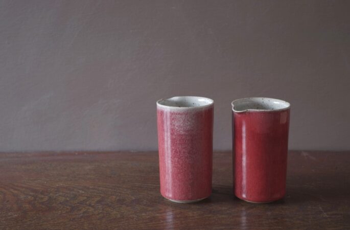 reduction fired, thrown stoneware small pourers with copper red glaze by award winning potters James and Tilla Waters in Carmarthenshire, Wales, UK