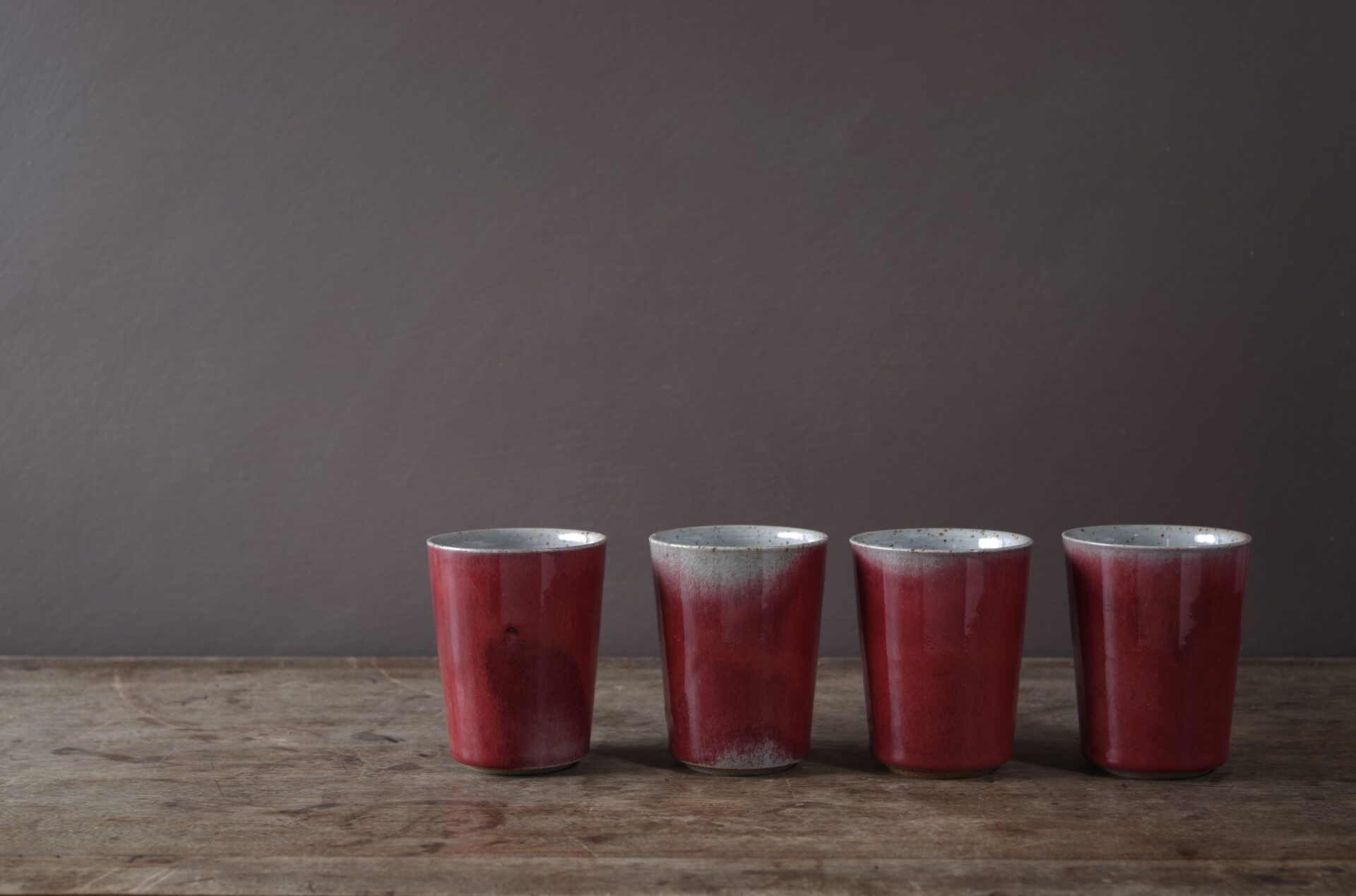 wheel thrown reduction fired stoneware beakers with copper red glaze by award winning studio potters James and Tilla Waters in Carmarthenshire, Wales, UK
