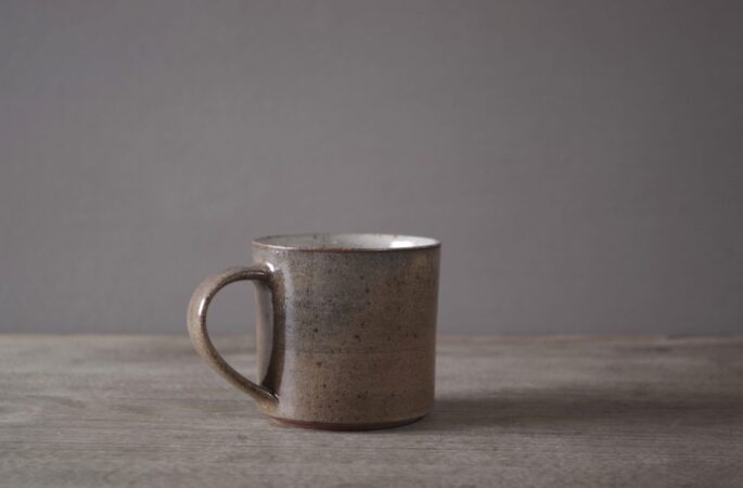 reduction fired thrown stoneware smallish coffee cups (150 ml) with pulled handle and neutral clear glaze by award winning potters James and Tilla Waters in their pottery in Carmarthenshire, Wales