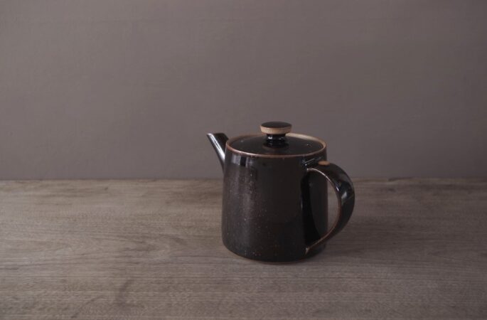 wheel thrown, reduction fired stoneware teapot with pulled handle and tenmoku glaze by award winning potters James and Tilla Waters in Carmarthenshire, Wales, UK