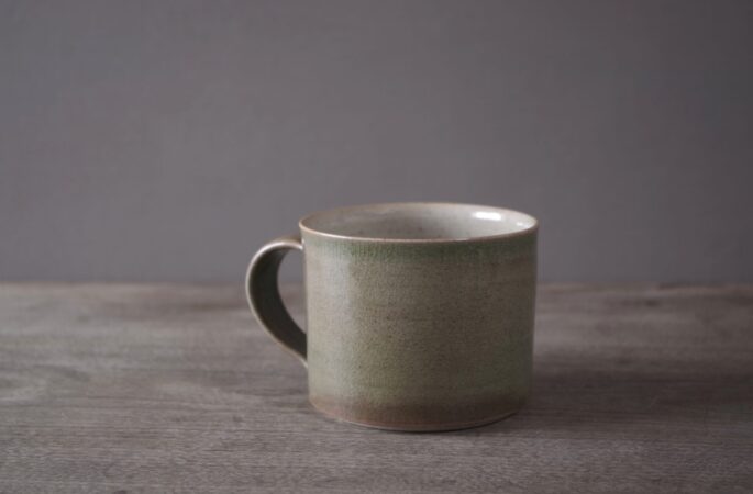 reduction fired stoneware breakfast mug with neutral green glaze by award winning potters James and Tilla Waters in Carmarthenshire, Wales, UK