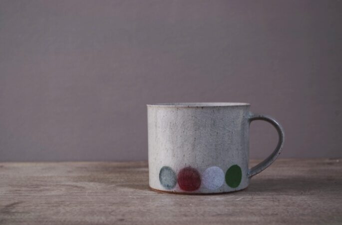 reduction fired stoneware breakfast mug with stencilled circle, decoration, crackle glaze and pulled handle by award winning potters James and Tilla Waters in Carmartheshire, Wales, UK