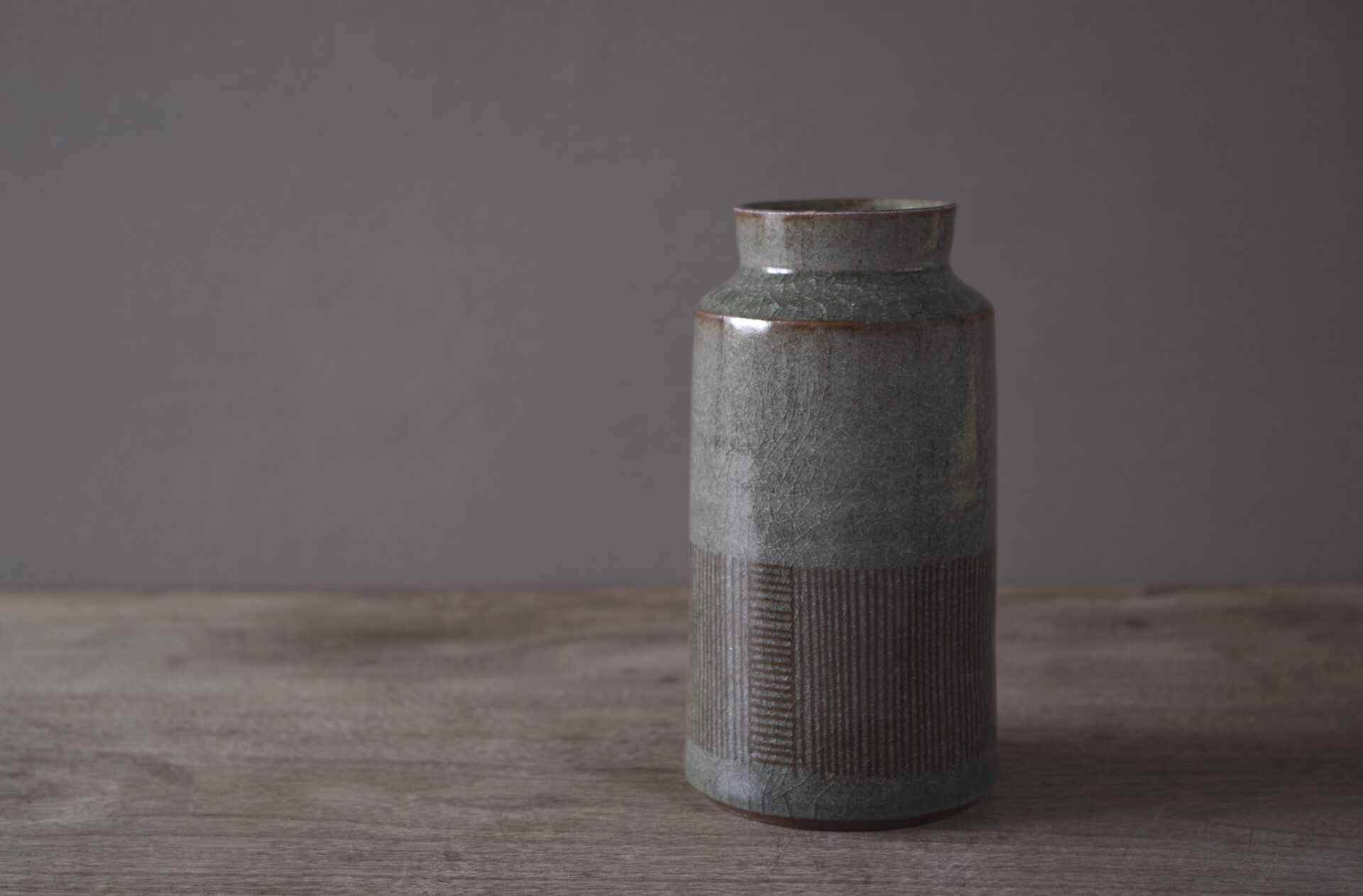 reduction fired thrown stoneware vase with inlaid decoration and neutral clear glaze by award winning potters James and Tilla Waters in their pottery in Carmarthenshire, Wales