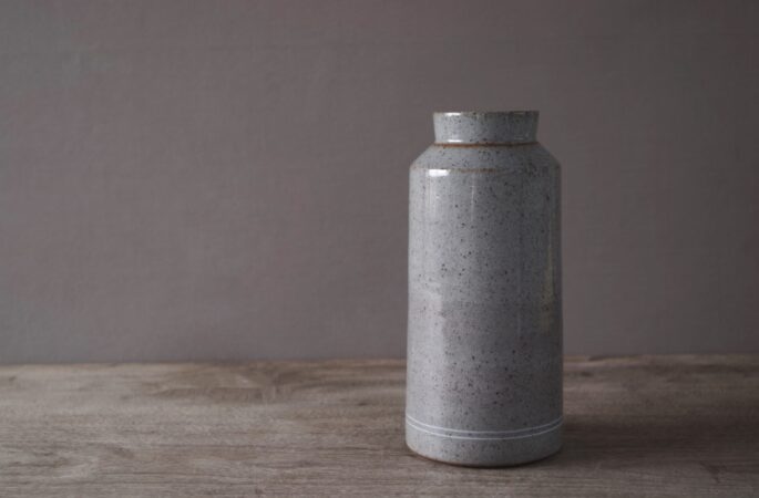 reduction fired thrown stoneware vase with inlaid decoration and neutral clear glaze by award winning potters James and Tilla Waters in their pottery in Carmarthenshire, Wales