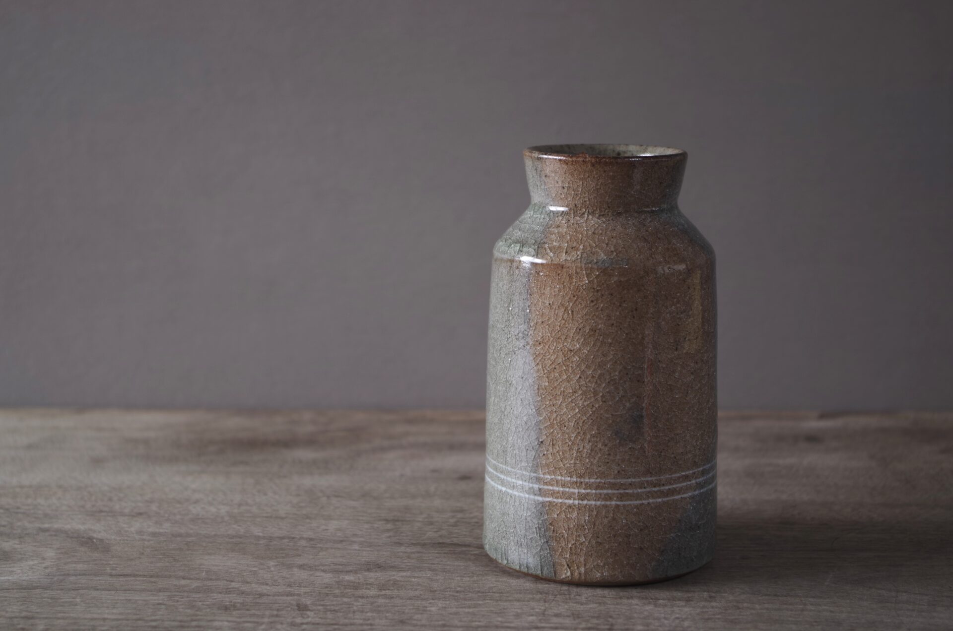 reduction fired thrown stoneware vase with inlaid decoration and neutral clear glaze by award winning potters James and Tilla Waters in their pottery in Carmarthenshire, Wales