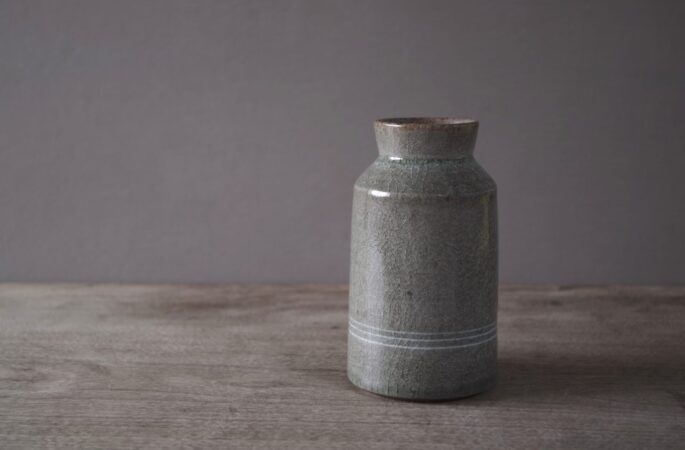 reduction fired thrown stoneware vase with inlaid decoration and neutral clear glaze by award winning potters James and Tilla Waters in their pottery in Carmarthenshire, Wales