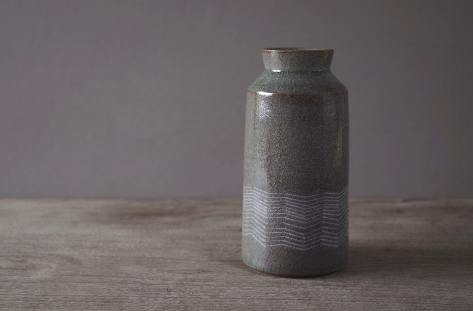 reduction fired thrown stoneware vase with inlaid decoration and neutral clear glaze by award winning potters James and Tilla Waters in their pottery in Carmarthenshire, Wales