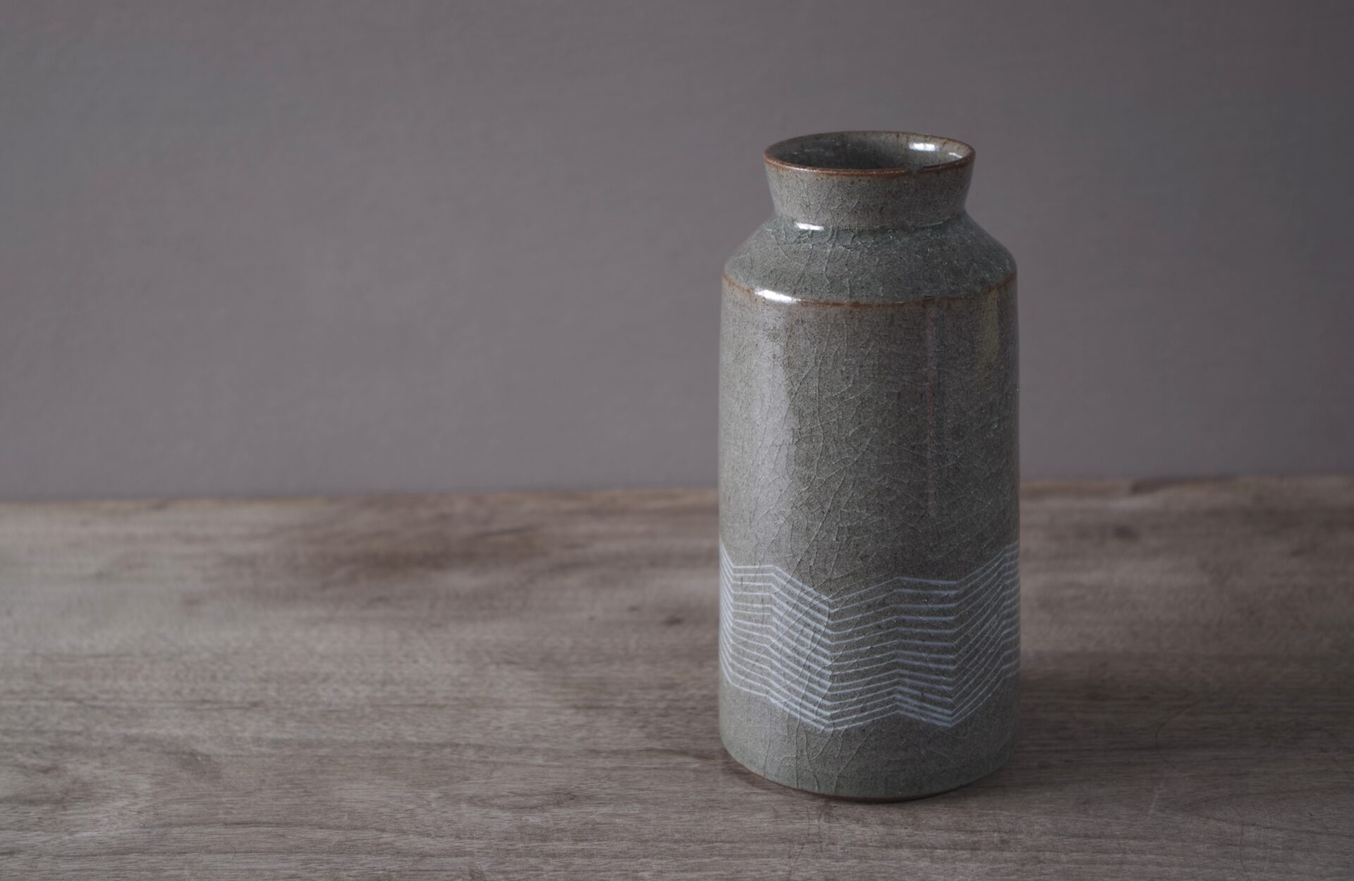 reduction fired thrown stoneware vase with inlaid decoration and neutral clear glaze by award winning potters James and Tilla Waters in their pottery in Carmarthenshire, Wales