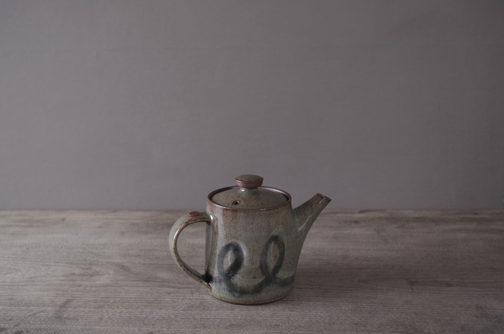 wheel thrown, reduction fired stoneware teapot with pulled handle and brushed loopy decoration by award winning potters James and Tilla Waters in Carmarthenshire, Wales, UK