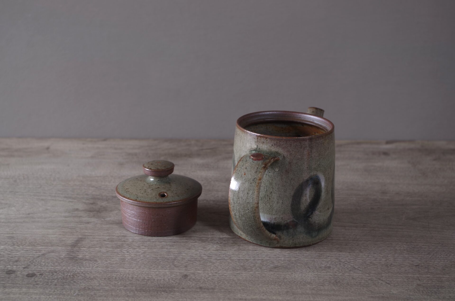 wheel thrown, reduction fired stoneware teapot with pulled handle and brushed loopy decoration by award winning potters James and Tilla Waters in Carmarthenshire, Wales, UK