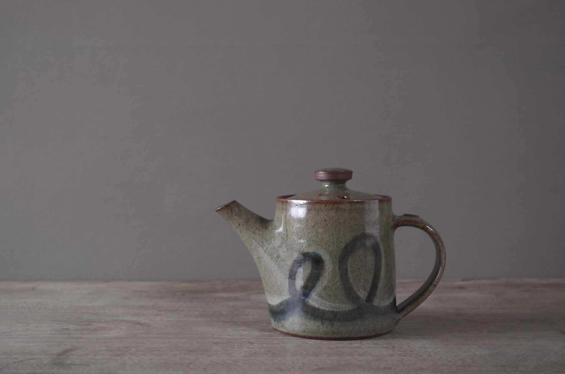 wheel thrown, reduction fired stoneware teapot with pulled handle and brushed loopy decoration by award winning potters James and Tilla Waters in Carmarthenshire, Wales, UK