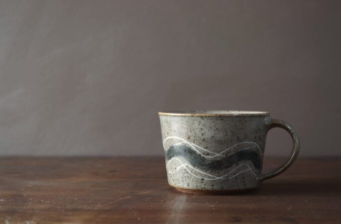 wheel thrown, reduction fired stoneware flared cup with inlaid geometric decoration and pulled handle by award winning potters James and Tilla Waters in Carmartheshire, Wales, UK