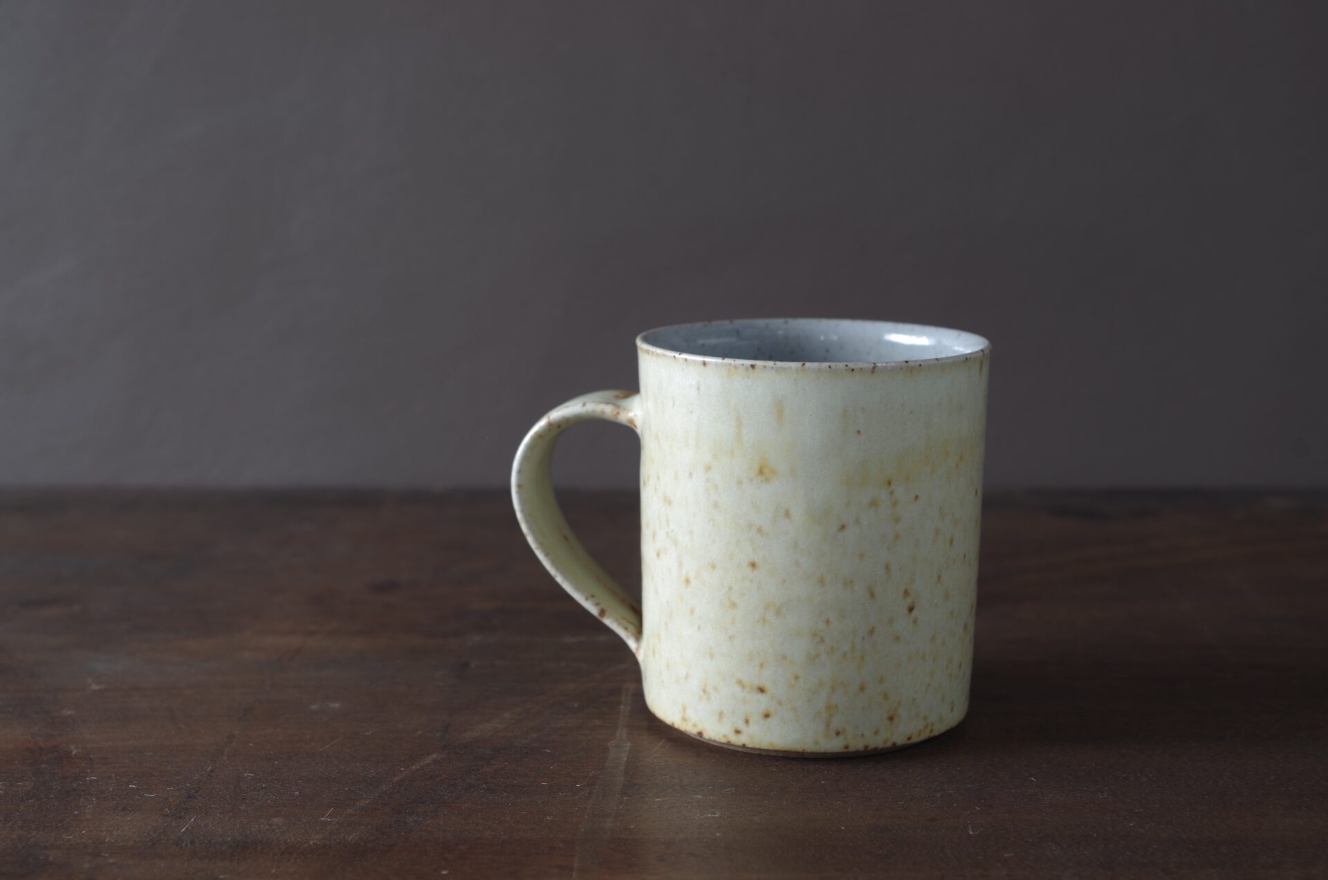 small reduction fired stoneware mug with not yellow glaze by award winning potters James and Tilla Waters in Carmarthenshire, Wales, UK