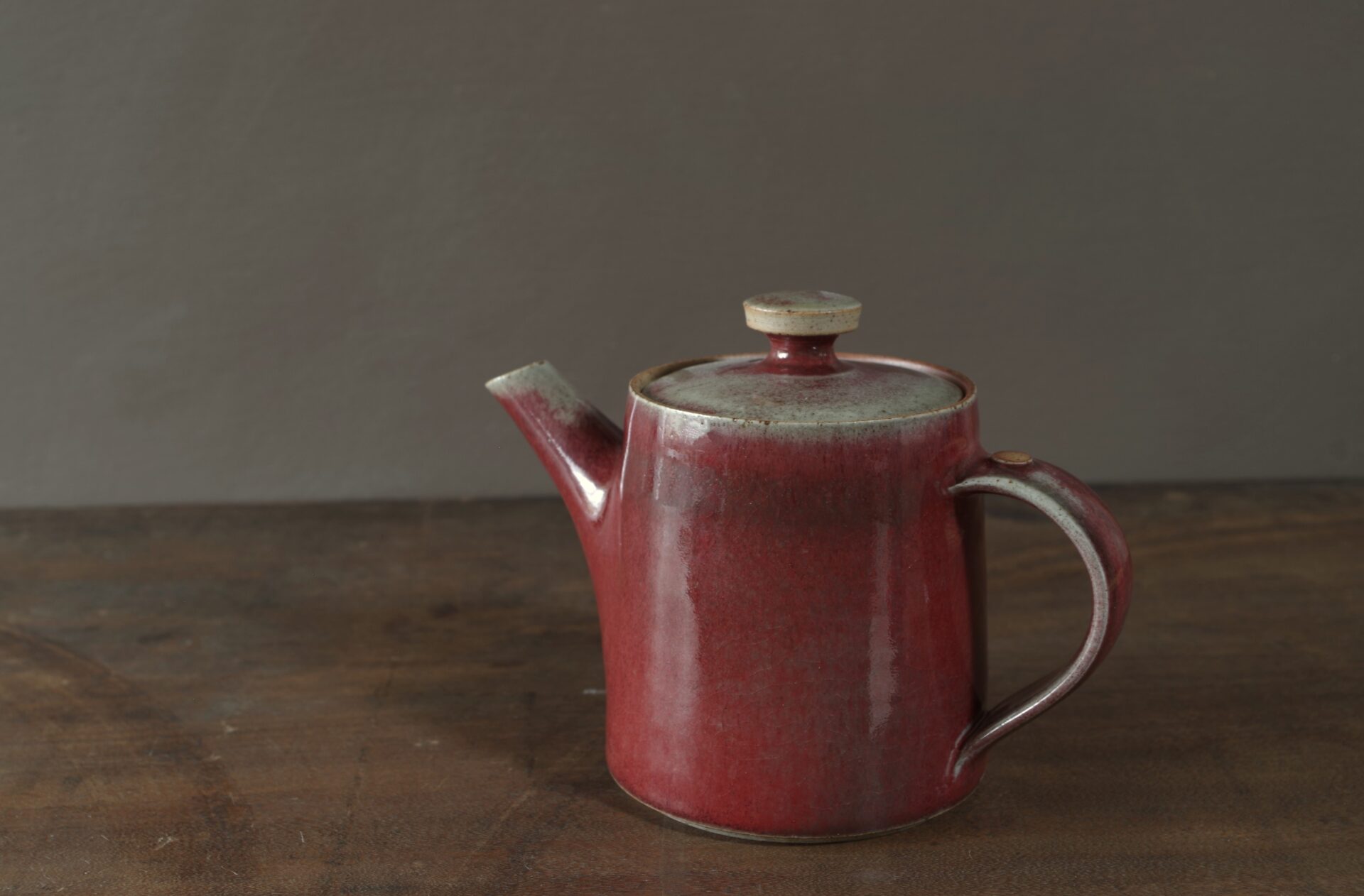 wheel thrown, reduction fired stoneware teapot with pulled handle and copper red glaze by award winning potters James and Tilla Waters in Carmarthenshire, Wales, UK