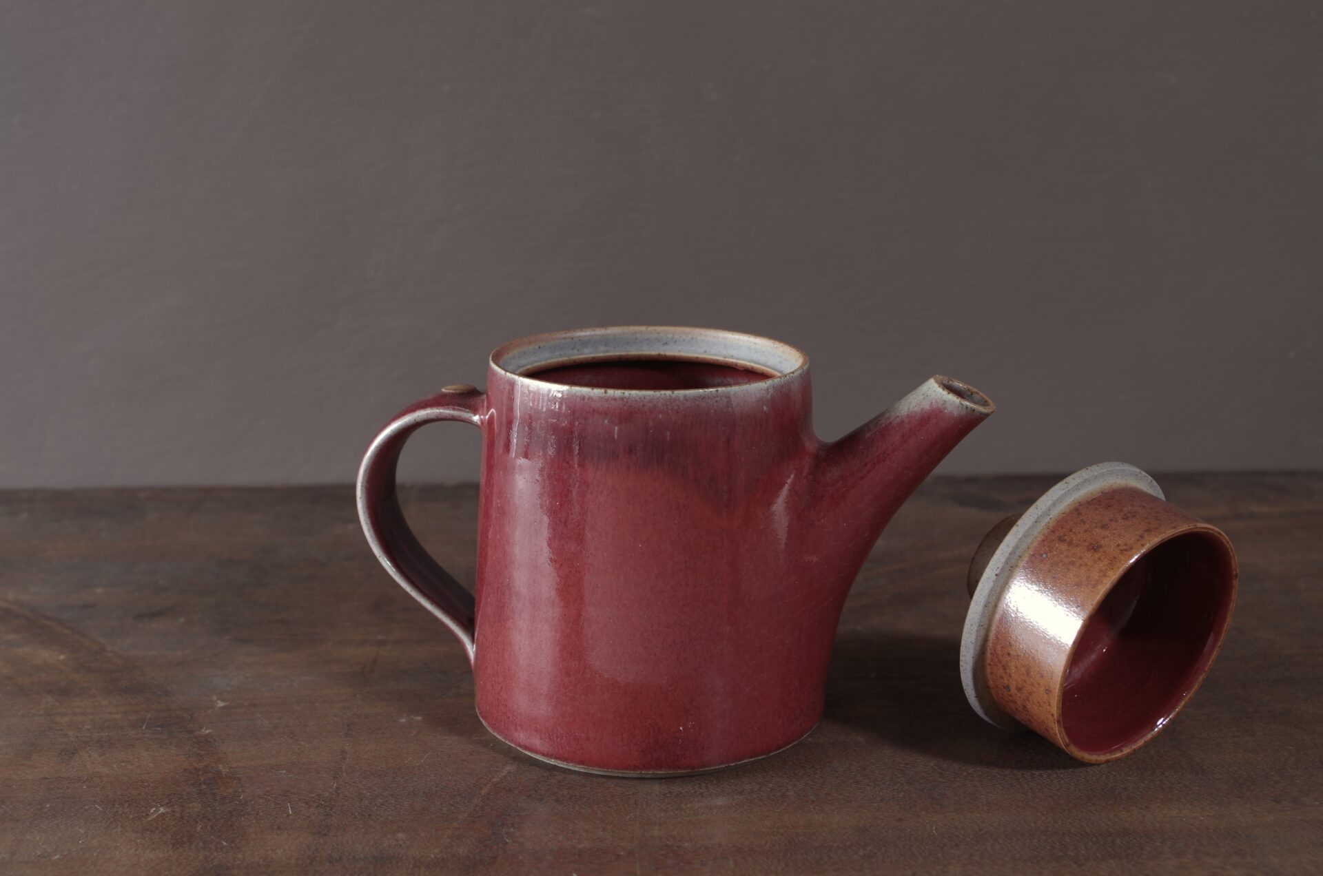 wheel thrown, reduction fired stoneware teapot with pulled handle and copper red glaze by award winning potters James and Tilla Waters in Carmarthenshire, Wales, UK