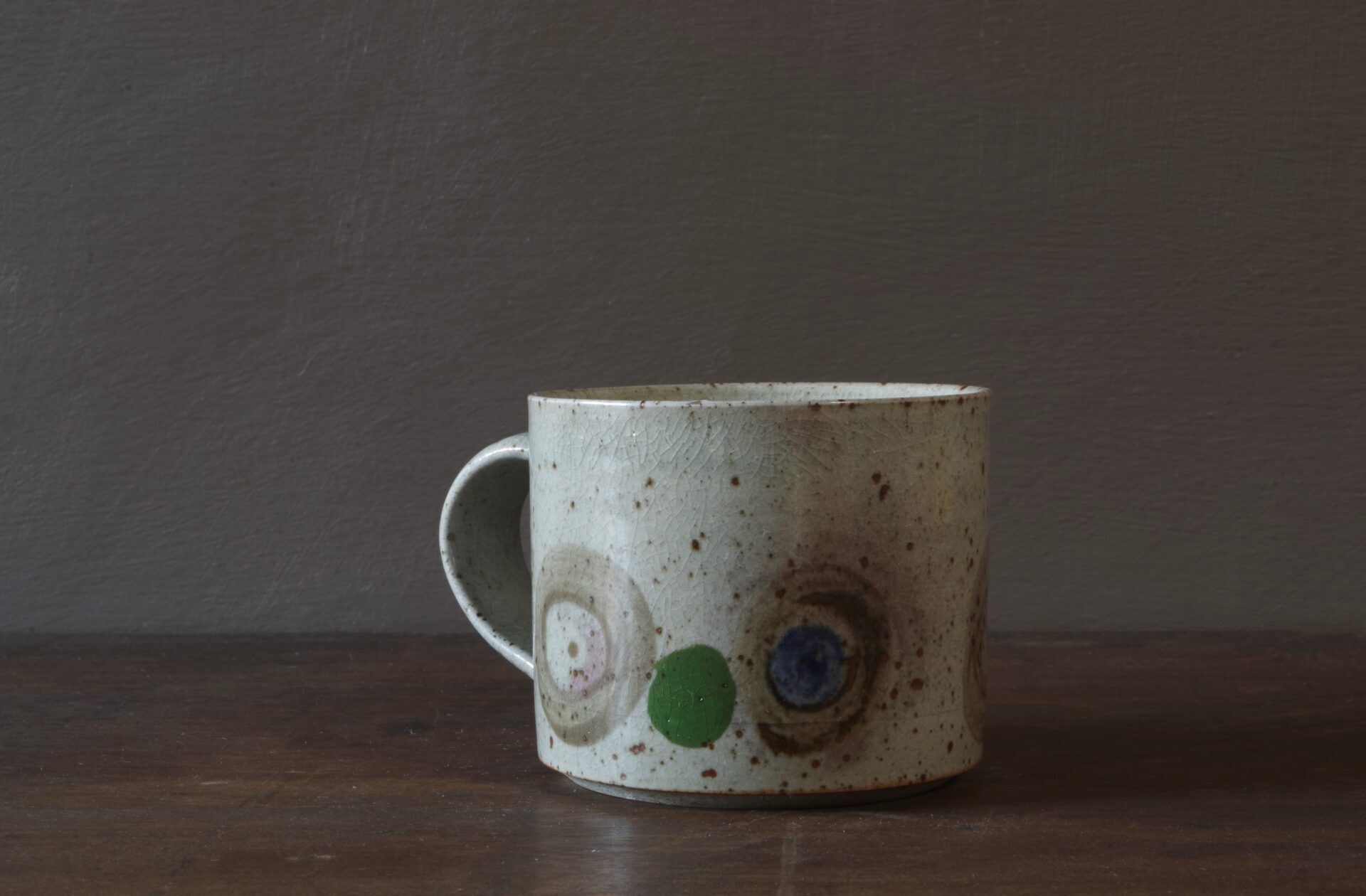 Reduction fired, wheel thrown, stoneware coffee cup with pulled handle and hand decorated by award winning studio potters James and Tilla Waters in Carmarthenshire, Wales, UK