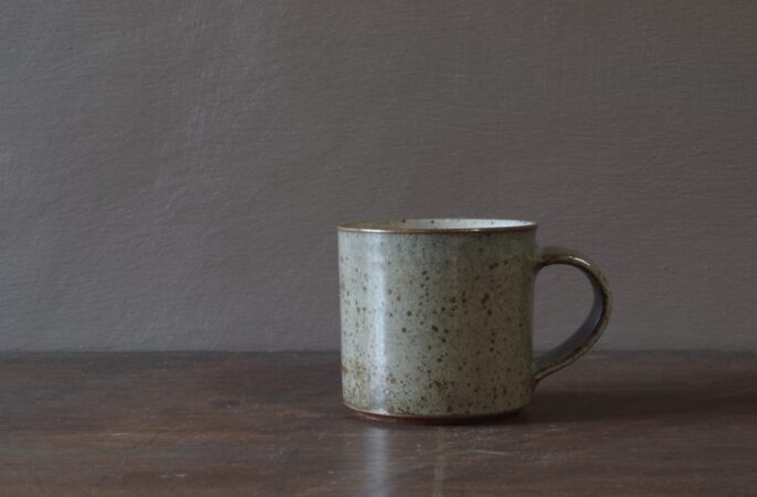 Reduction fired, wheel thrown, stoneware coffee cup with pulled handle and grey (clear) glaze by award winning studio potters James and Tilla Waters in Carmarthenshire, Wales, UK