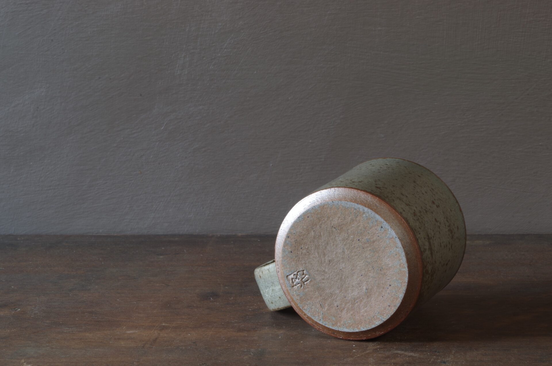 Reduction fired, wheel thrown, stoneware coffee cup with pulled handle and grey (clear) glaze by award winning studio potters James and Tilla Waters in Carmarthenshire, Wales, UK