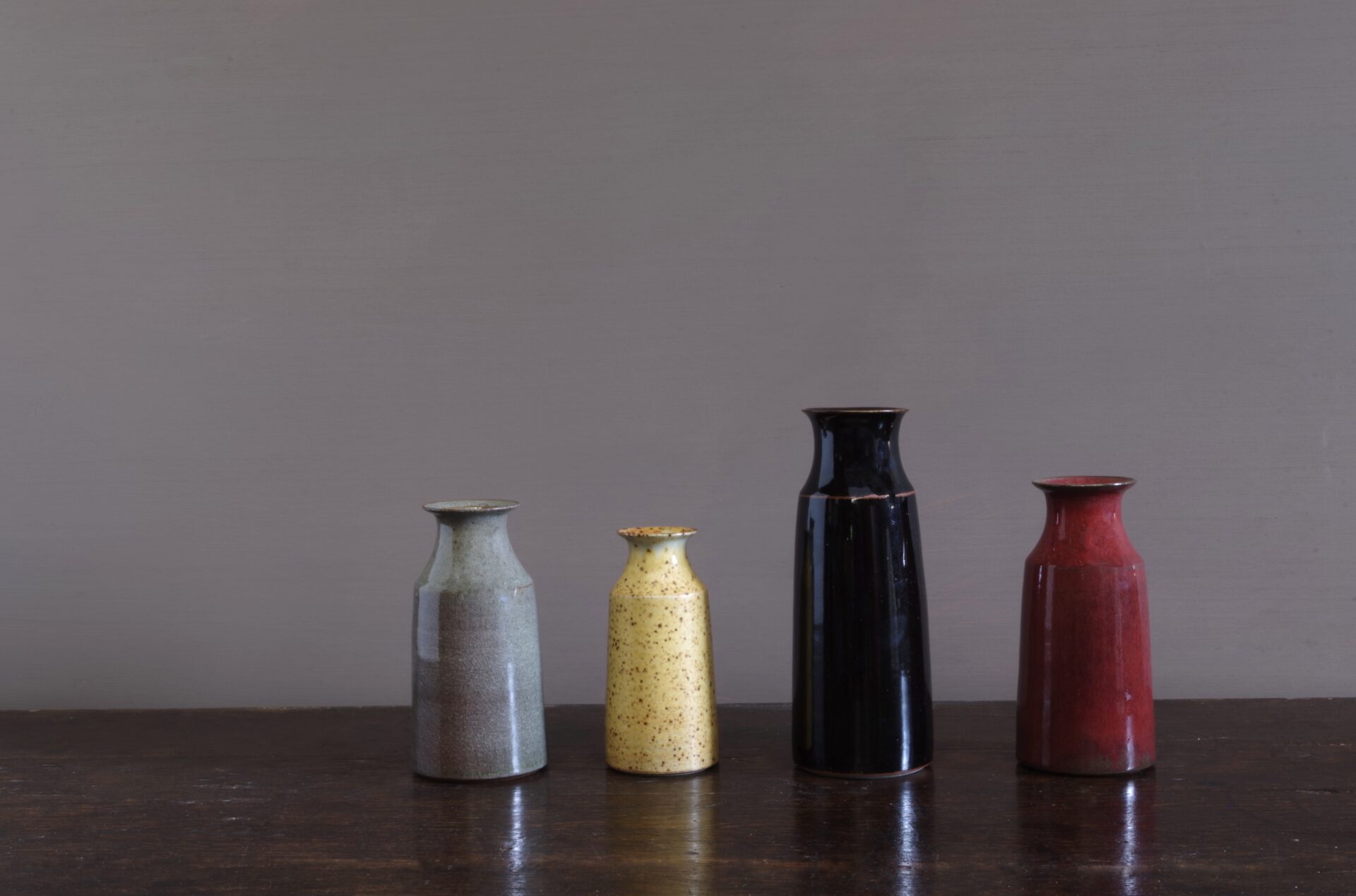 wheel thrown dark stoneware vase with tenmoku glaze, reduction fired by award winning potters James and Tilla Waters in Carmarthenshire, Wales, UK