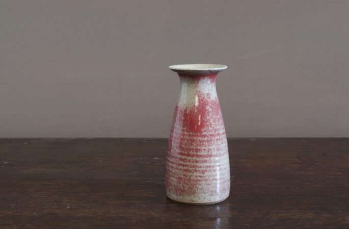 wheel thrown stoneware vase with slightly copper red glaze, reduction fired by award winning potters James and Tilla Waters in Carmarthenshire, Wales, UK