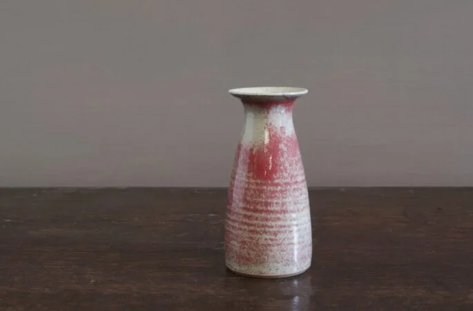 wheel thrown stoneware vase with slightly copper red glaze, reduction fired by award winning potters James and Tilla Waters in Carmarthenshire, Wales, UK