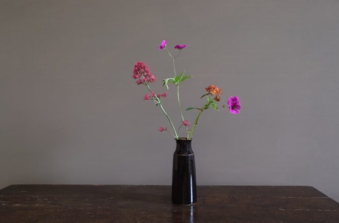 wheel thrown dark stoneware vase with tenmoku glaze, reduction fired by award winning potters James and Tilla Waters in Carmarthenshire, Wales, UK