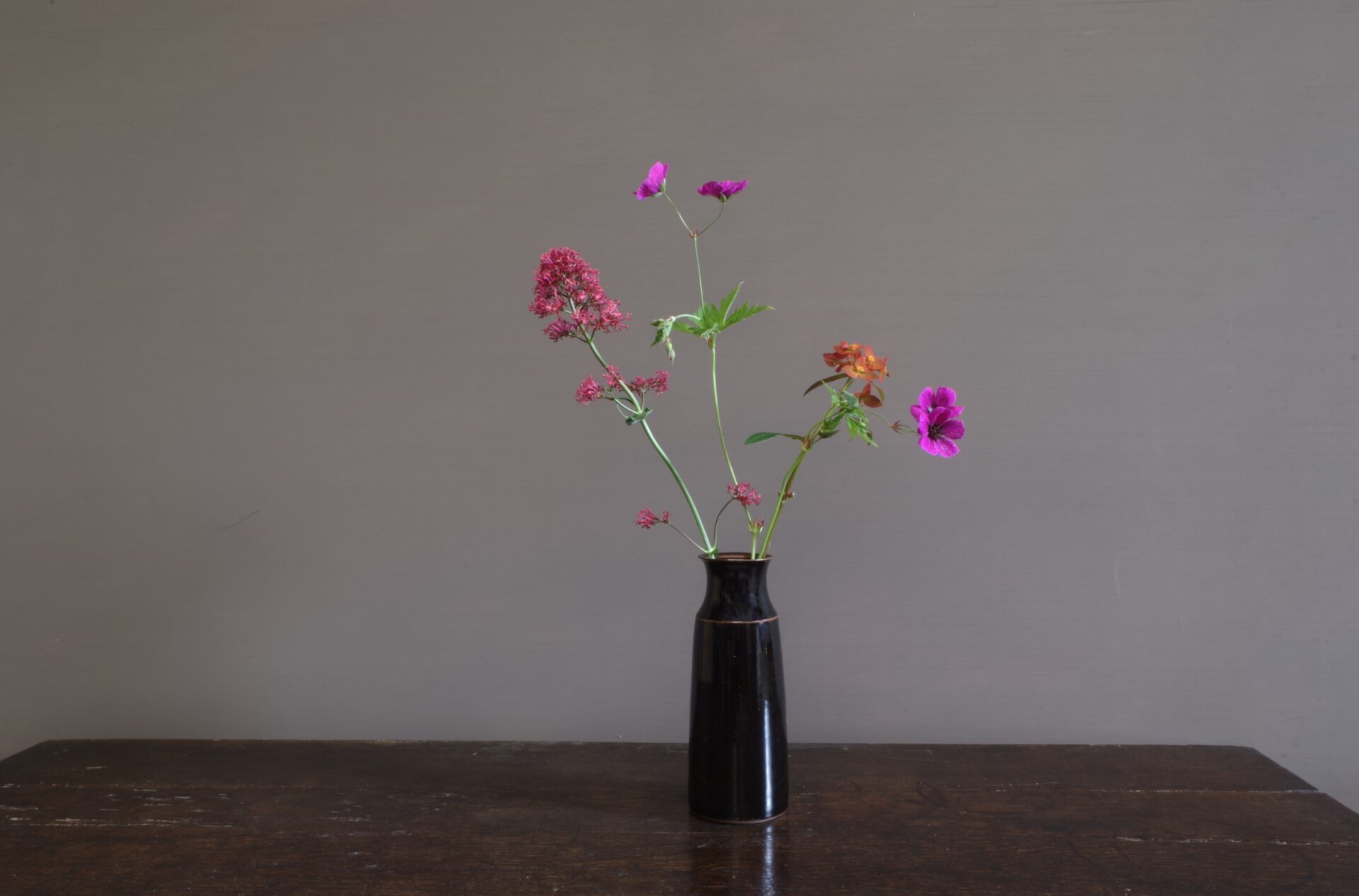 wheel thrown dark stoneware vase with tenmoku glaze, reduction fired by award winning potters James and Tilla Waters in Carmarthenshire, Wales, UK