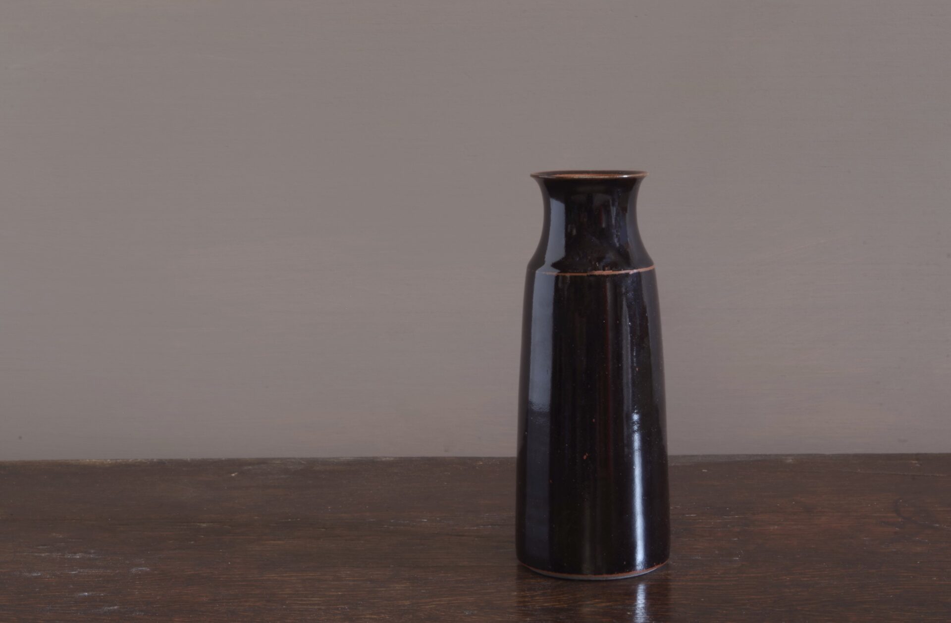 wheel thrown dark stoneware vase with tenmoku glaze, reduction fired by award winning potters James and Tilla Waters in Carmarthenshire, Wales, UK